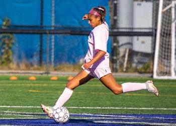 UB soccer player kicking the ball